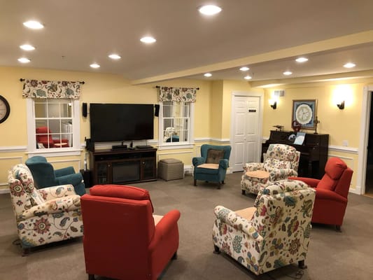 Cozy common area with colorful seating and a television