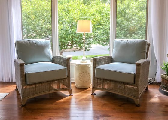 Cozy sitting area with two chairs by a window