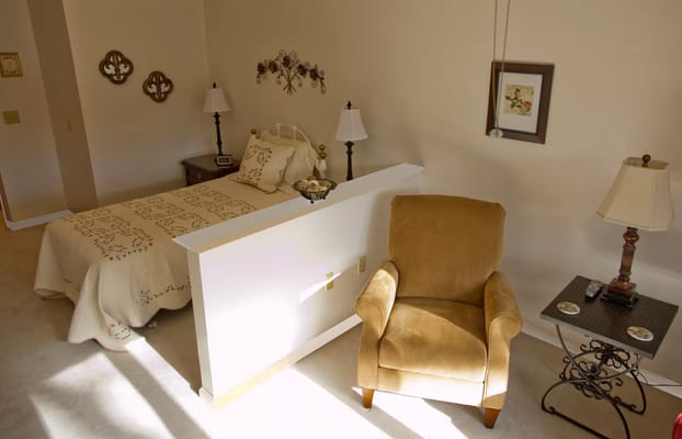 Cozy private resident room with a bed and chair