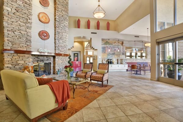Inviting lobby with seating and decorative stone wall