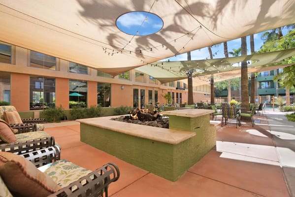 Cozy outdoor lounge with seating and fire pit at McDowell Village