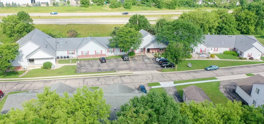 Aerial view of McFarland Villa with parking and green space