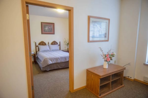 Cozy interior view of a resident room with a bed and decor