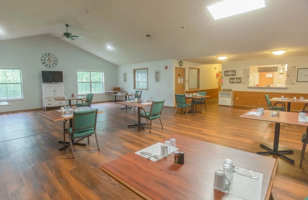 Bright dining room with tables set for meals