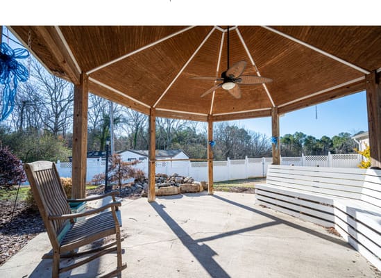 Outdoor gazebo with seating in a serene setting