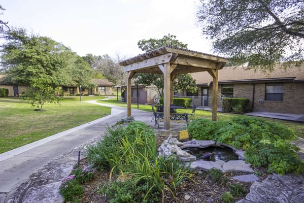 Garden pavilion with seating area and pond
