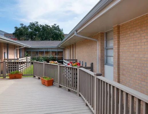 Outdoor patio area with planters and railing