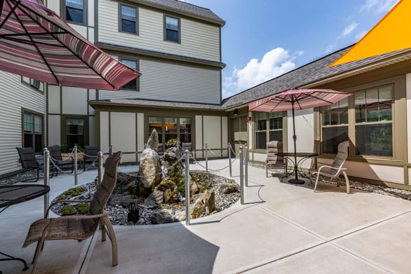 Outdoor seating area with umbrellas and a rock feature