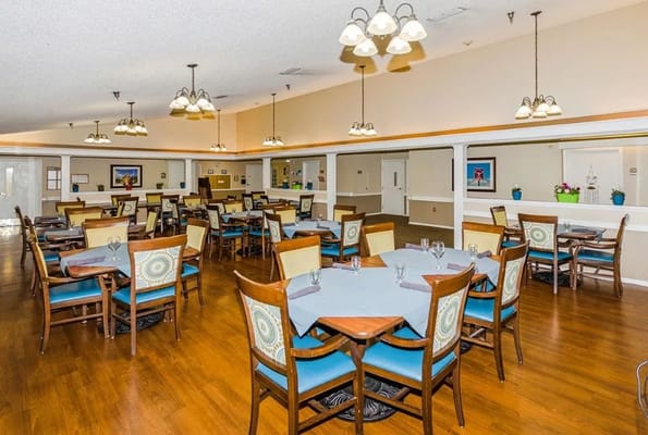 Dining area with tables and chairs set up for residents