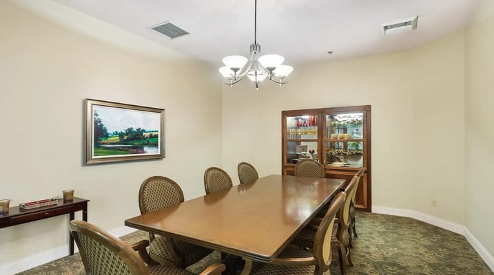 Bright common area with a dining table and artwork on the wall