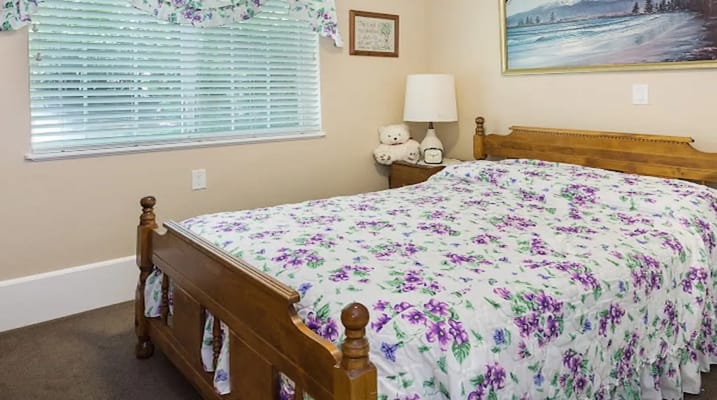 Cozy bedroom with floral bedding and soft lighting