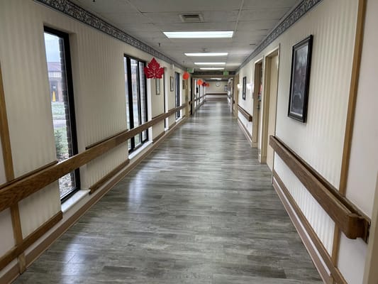 Spacious hallway with windows and wooden railings