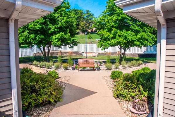 View of a landscaped outdoor seating area with trees