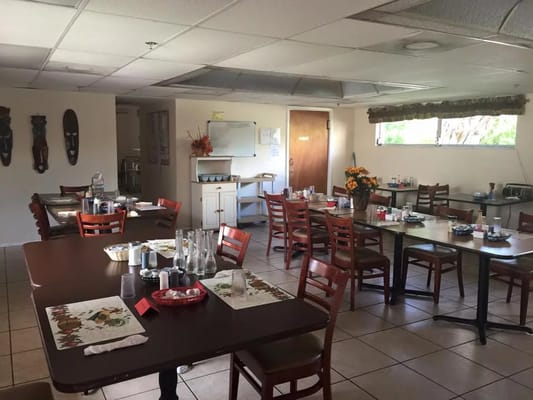 Dining area with tables and chairs set for meals