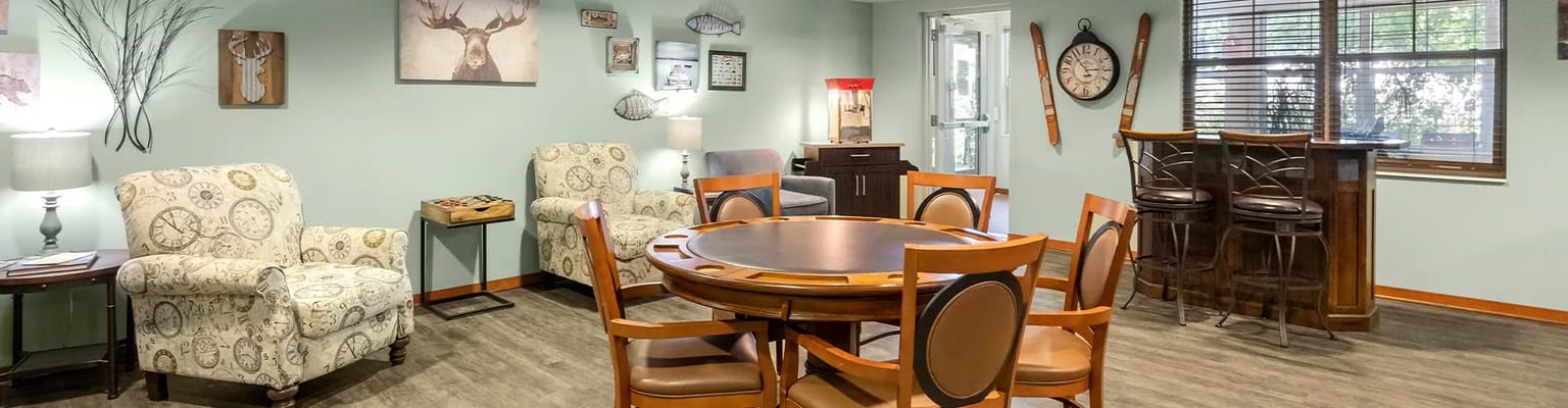 Cozy common area with seating and games at Minnehaha Senior Living