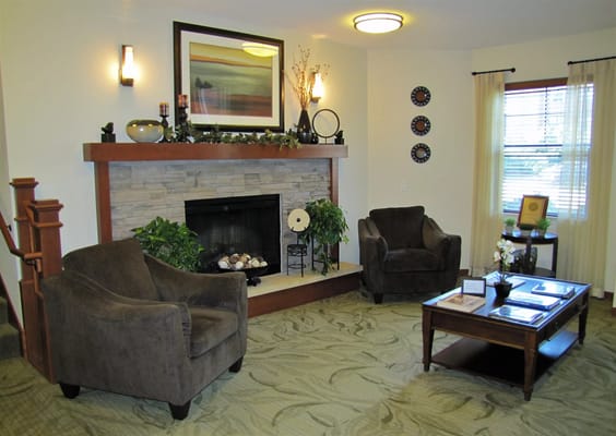Comfortable living area with armchairs and a fireplace