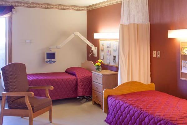 A shared resident room with two beds and decor