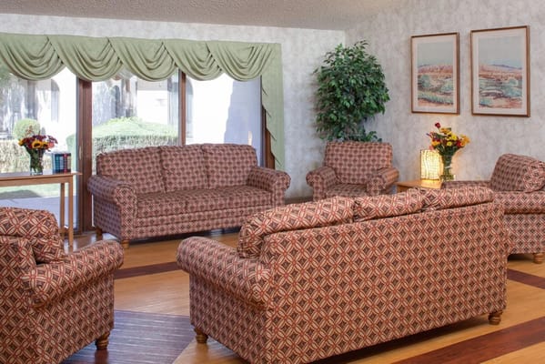Cozy common area with patterned furniture and window view