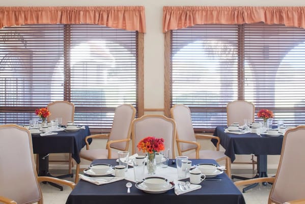 Dining area with tables set for residents