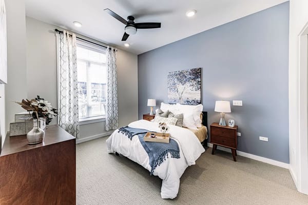 Well-decorated private resident room with bed and art