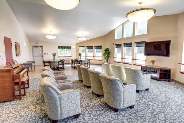 Bright common area with seating and piano