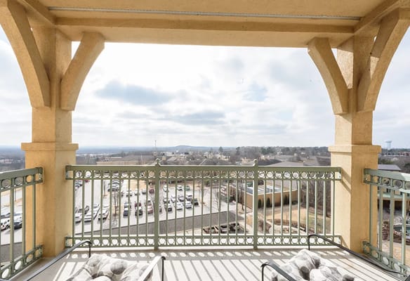 View from the balcony showing a cloudy sky and the surrounding area.