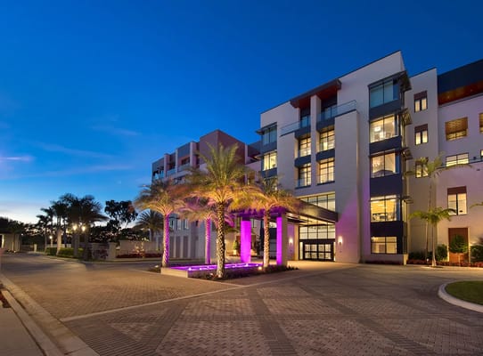 Exterior view of a modern senior living facility at dusk