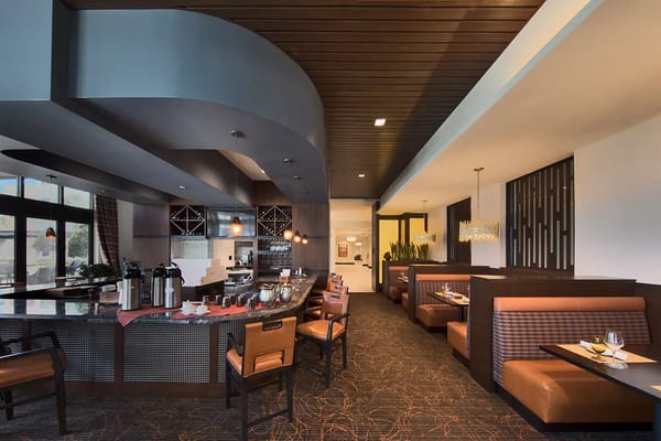 Bright dining area with booths and a coffee station