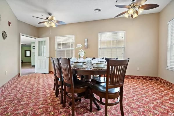 Dining area with a large wooden table and chairs