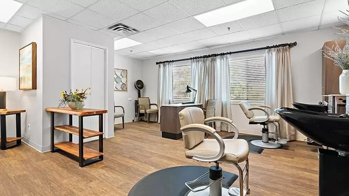Bright interior salon area with styling chairs and stations