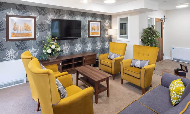 A cozy common area with stylish yellow chairs
