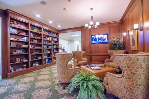 Library lounge with bookshelves and comfortable seating.
