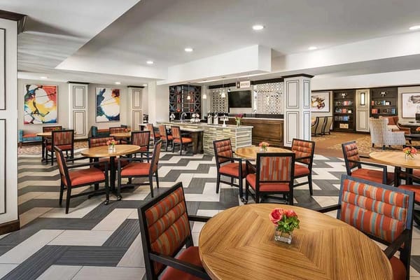 Interior view of a dining area with tables and chairs