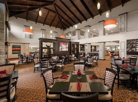 Dining area with tables and chairs set for a meal