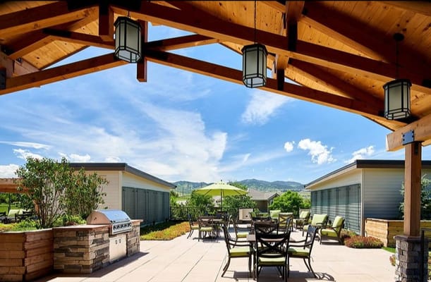 Patio area with tables and shaded umbrellas overlooking the landscape