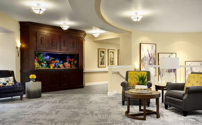 Bright interior common area with seating and aquarium