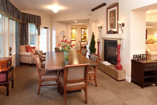 Bright interior common area with a large table and seating