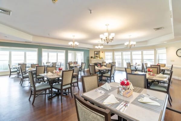 Dining area with tables and chairs set for a meal