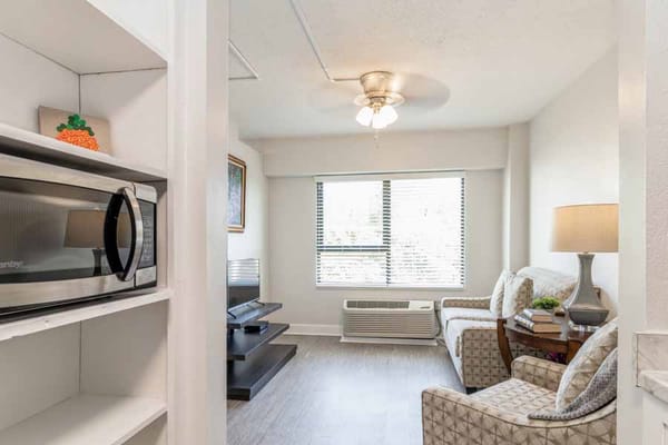 Living area featuring a microwave, comfortable seating, and a window