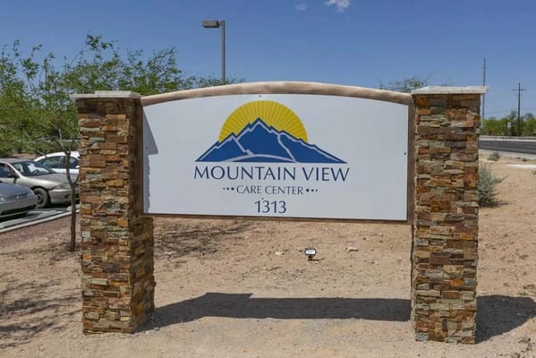 Signage for Mountain View Care Center with mountains in the background