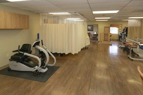 Rehabilitation gym with exercise equipment and privacy curtains