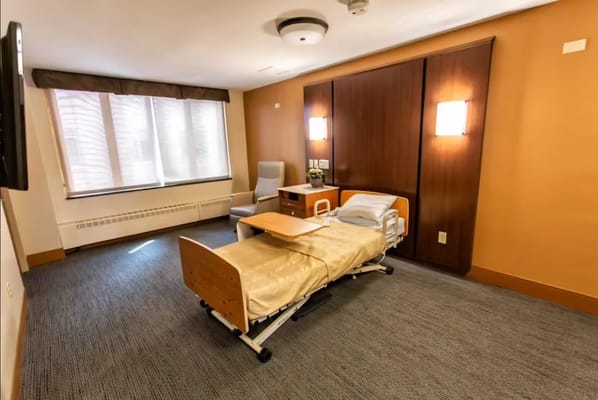 Private resident room with hospital bed and window
