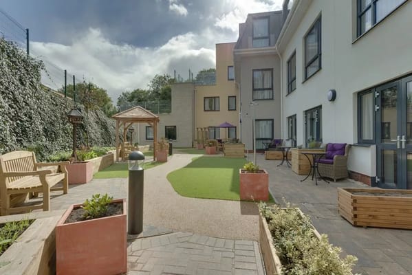 Outdoor space with gardens and seating at the care home