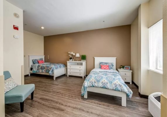 Private resident room with two beds and decor