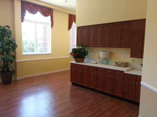 Interior view of the kitchen area with cabinets and plants
