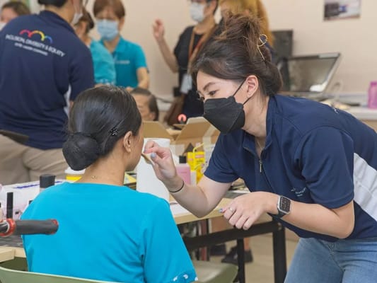 Staff assisting a resident during an activity session