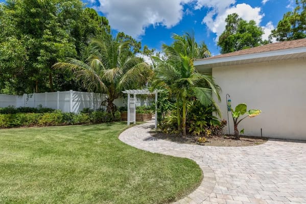 Lush garden with palm trees and pathway