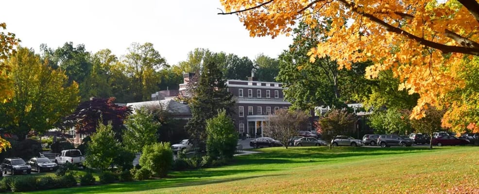 Exterior view of The Nathaniel Witherell surrounded by autumn foliage