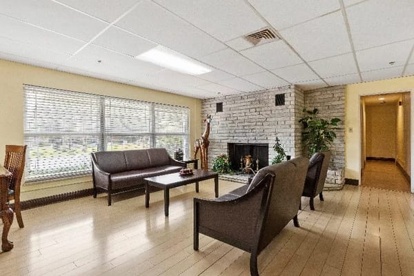 Spacious lounge area with comfortable seating and a fireplace