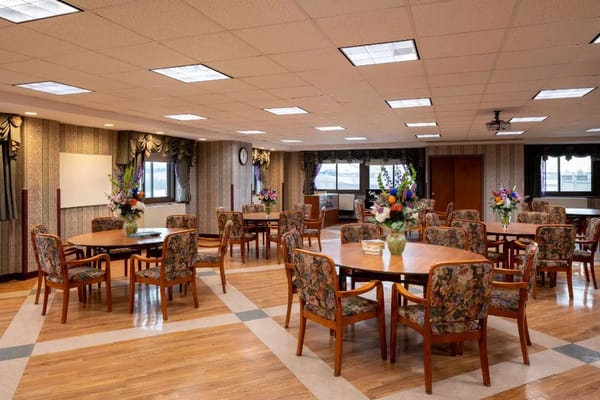 Bright common area with floral decorations and tables